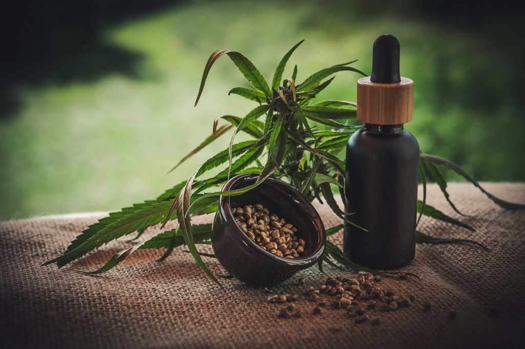 CBD bottle with a plant and seeds