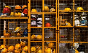 Security locker with assorted safety hats.