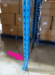 Damaged pallet rack upright column.