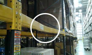 Circle highlighting a damaged pallet rack beam.