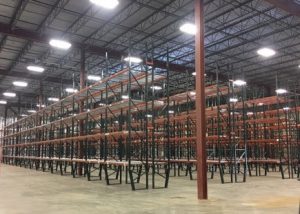 Interior warehouse with many rows of selective pallet rack.