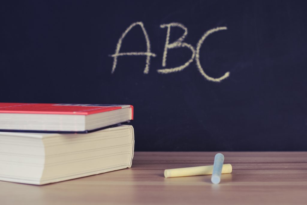 Chalkboard with ABC written in yellow chalk.