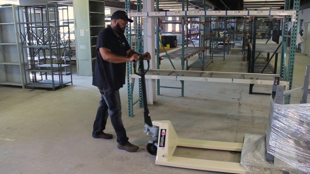 Employee demonstrates how to use a pallet jack.