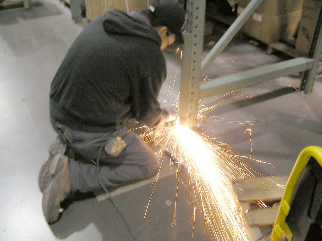 Employee cuts out damaged upright section