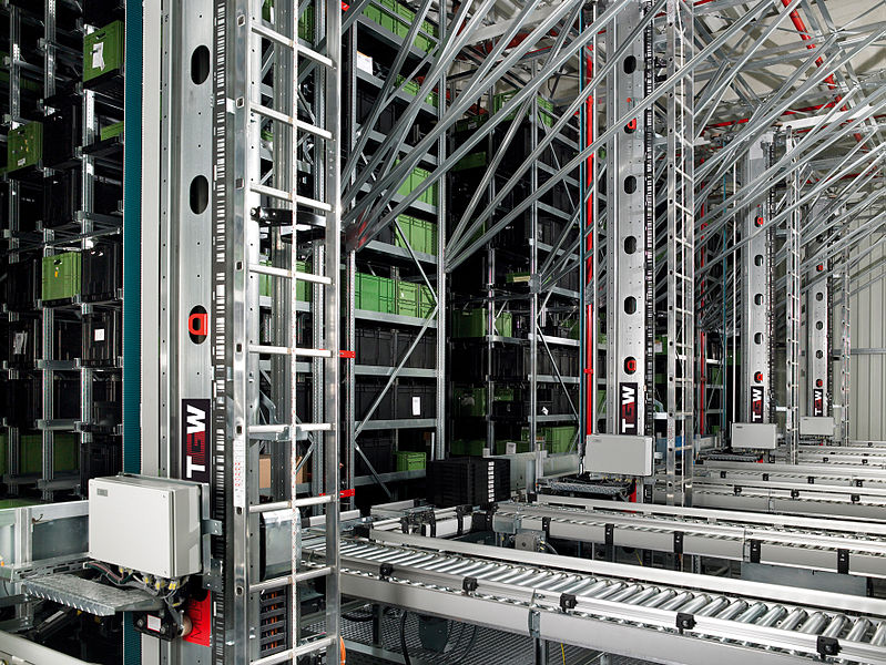 An automated storage and retrieval system (AS/RS) set up in a warehouse. 