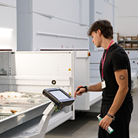 Employee using a vertical lift module system