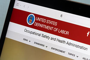 A laptop shows the United States Department of Labor website.