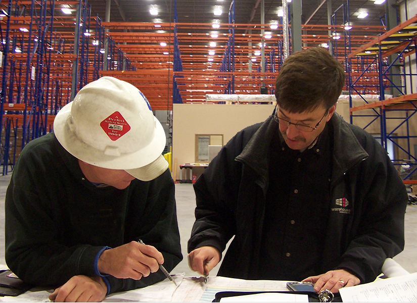 Consultants look over a layout design during warehouse install
