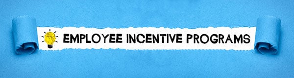 Text “employee incentive programs” revealed by rolling back blue fabric.
