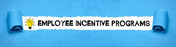 Text “employee incentive programs” revealed by rolling back blue fabric.