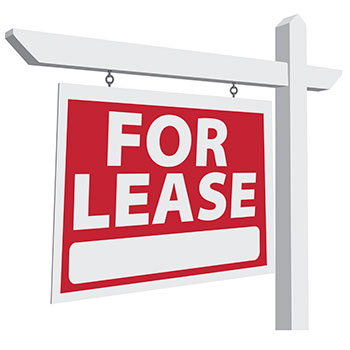 For Lease sign with white text on red, hanging from a white post.