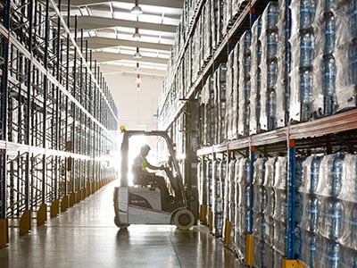 Forklift picks a pallet off of a pallet rack