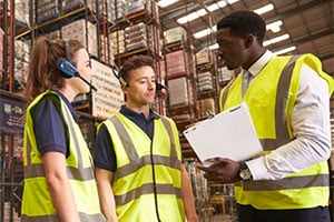 Warehouse workers discussing pallet storage