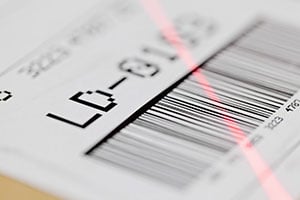 Barcode with a laser pointing at it to scan it for shipping information.