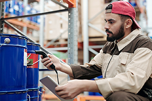 Warehouse employee uses a scanner.