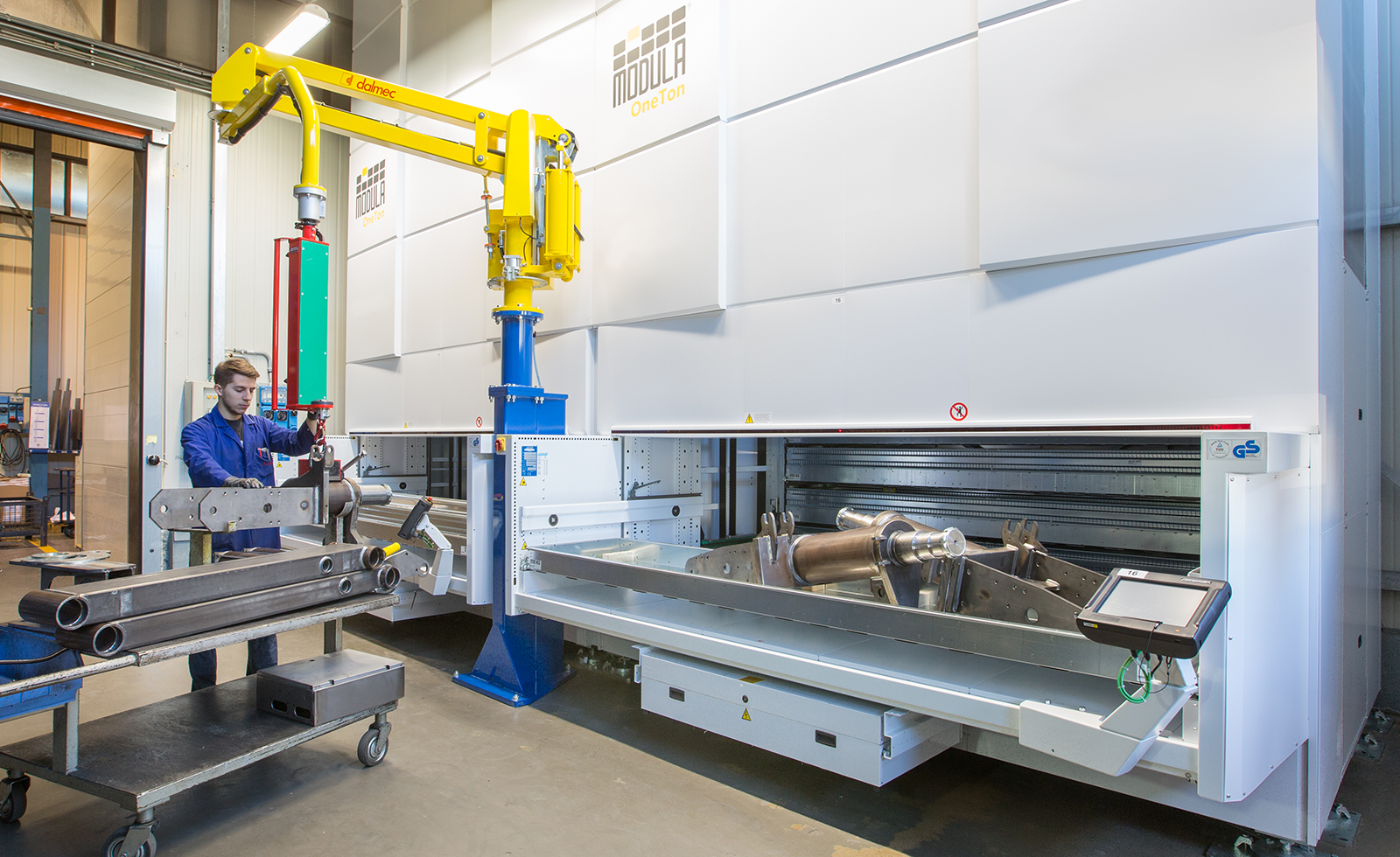 VLM operator uses a robotic arm to pick heavy components