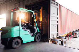 Warehouse worker loads a semi trailer.