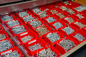 Organized plastic bins filled with small parts.