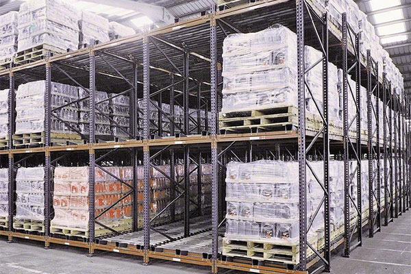 Loaded pallets on a rack system that are easily accessible by a wide aisle.