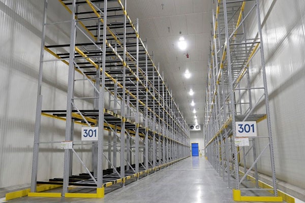 Empty pallet racks set up in a cold storage warehouse.