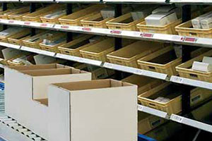 Pick to light system on shelves with bins of products. 