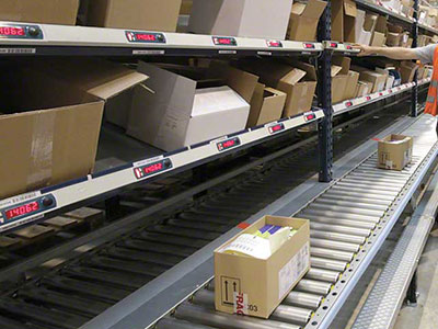 Pick to light system above a conveyor.