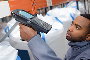 Warehouse worker scans a barcode.