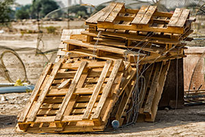 Pile of pallets that have been thrown out and left exposed to the elements.