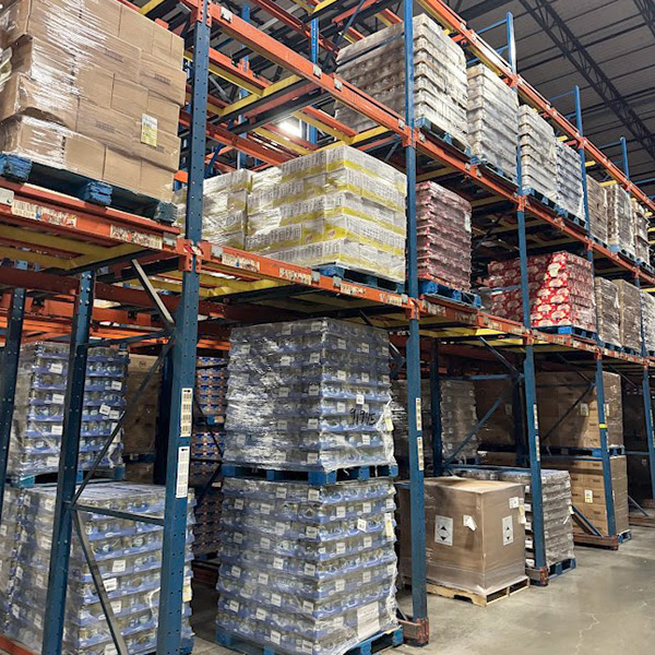 Multiple rows of structural pushback rack in a warehouse