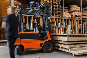 Forklift next to pallet racks in a warehouse