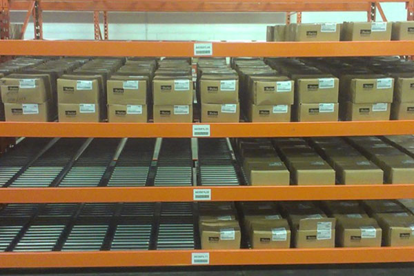Close up view of a roller rack holding small boxes.