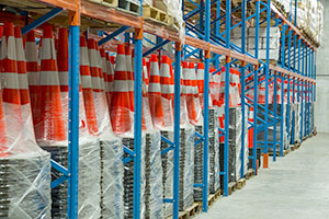 Pallets of safety cones in a warehouse.