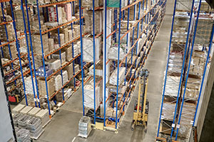 Broad view of racked products lining warehouse aisles.