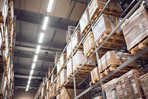 Pallets stored on tall pallet racks in warehouse