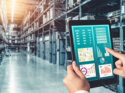 Warehouse reports show KPIs on a tablet.