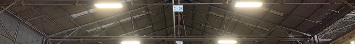 Highly efficient lighting fixtures hang from the ceiling of a warehouse