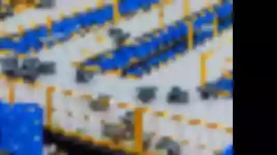 Multiple sorting robots work in a warehouse full of bins