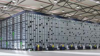 Warehouse employees operate ASRS Opex Infinity system