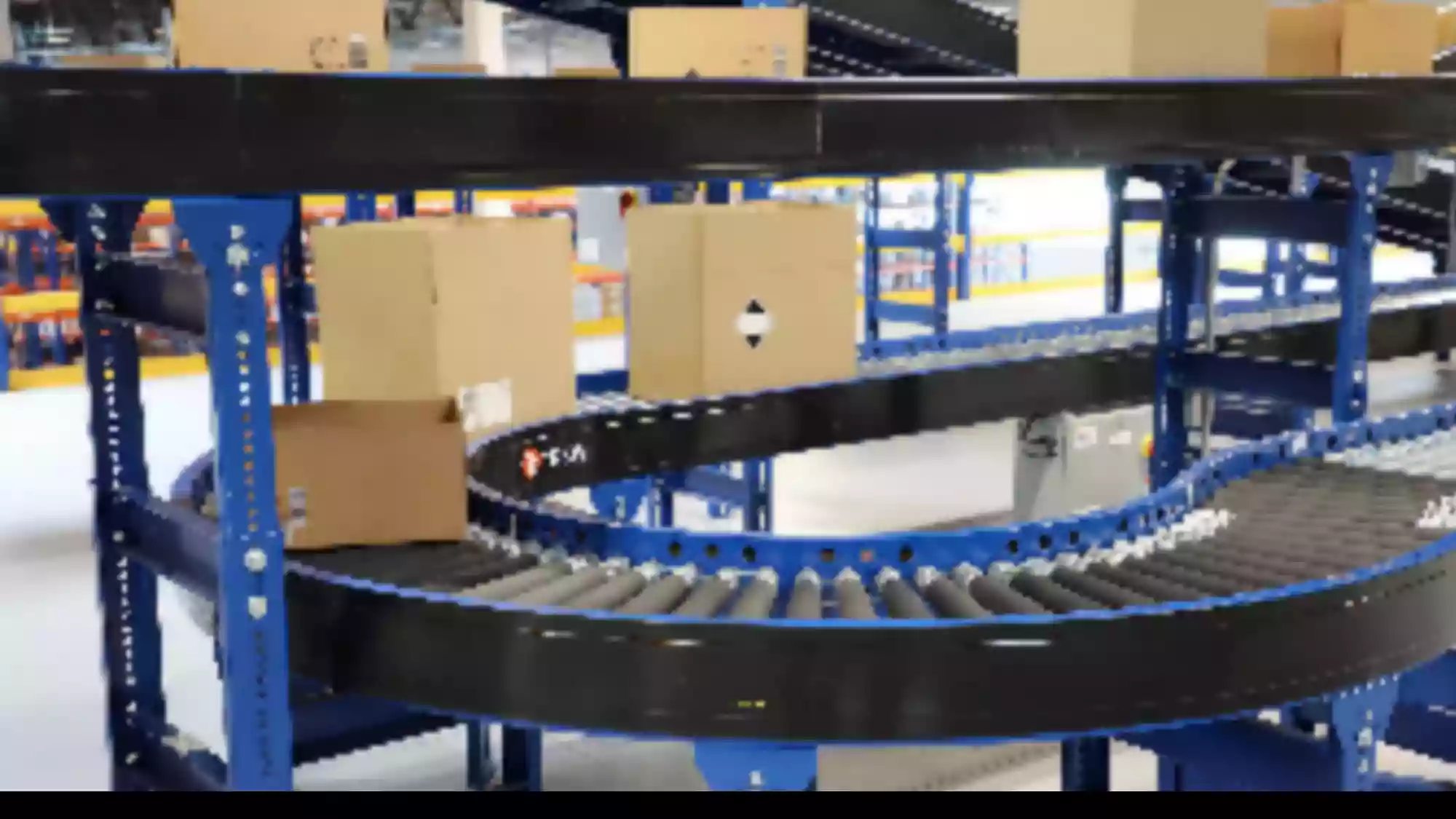 Close-up of an automated conveyor line transporting boxes in a warehouse