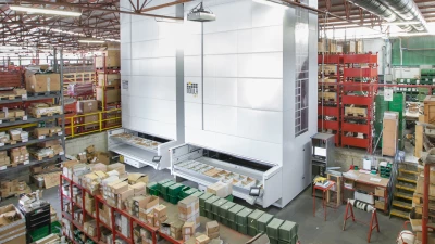 Smart warehouse with two vertical lift modules among shelving and pallet rack