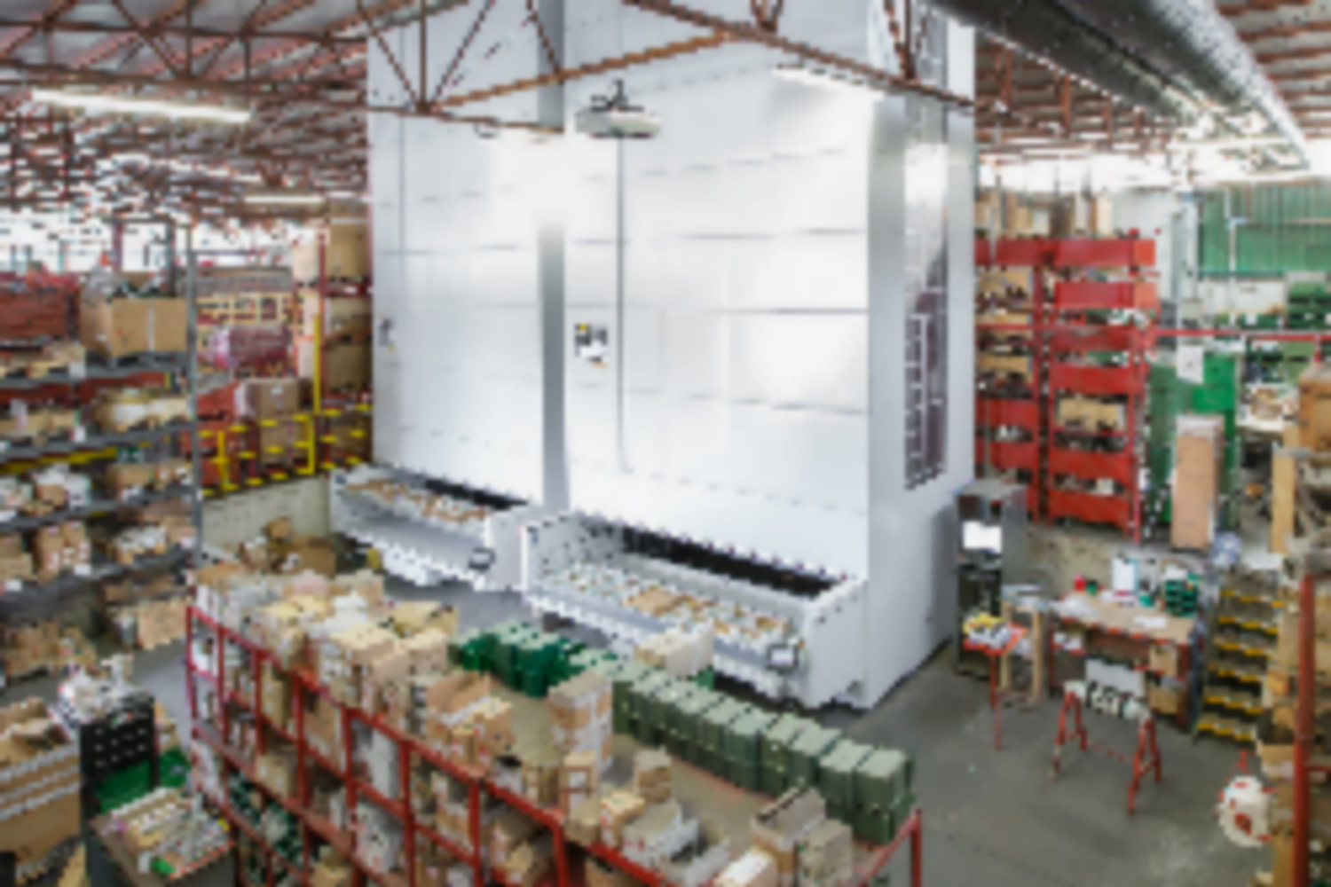 Smart warehouse with two vertical lift modules among shelving and pallet rack