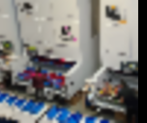 Two employees pick parts from vertical lift module trays