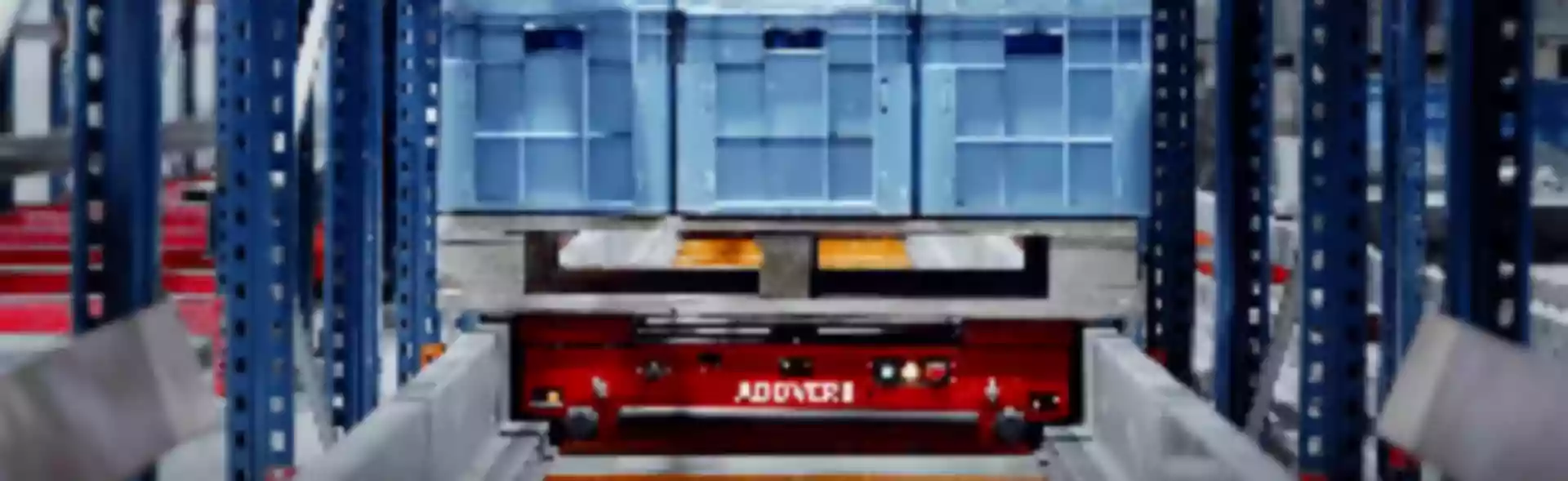 Pallet shuttle sits inside racking system ready to put away palletized goods