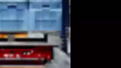 Pallet shuttle sits inside racking system ready to put away palletized goods