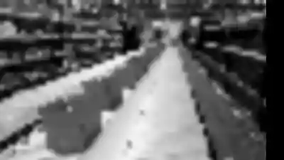 Pick module system in a warehouse with boxes on conveyor and gravity flow rack