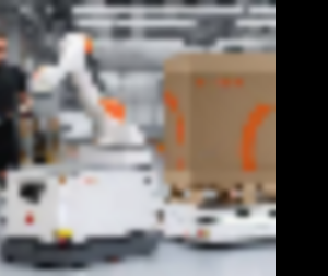 Warehouse employee sets up an autonomous mobile robot
