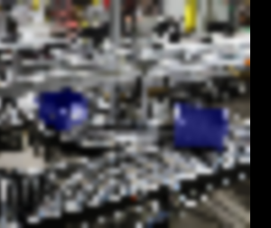 Blue bins divert on rollers of a conveyor system