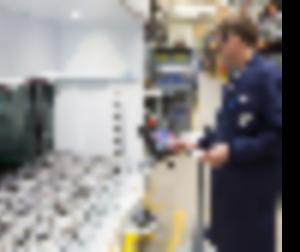 An employee picks parts from vertical lift module tray